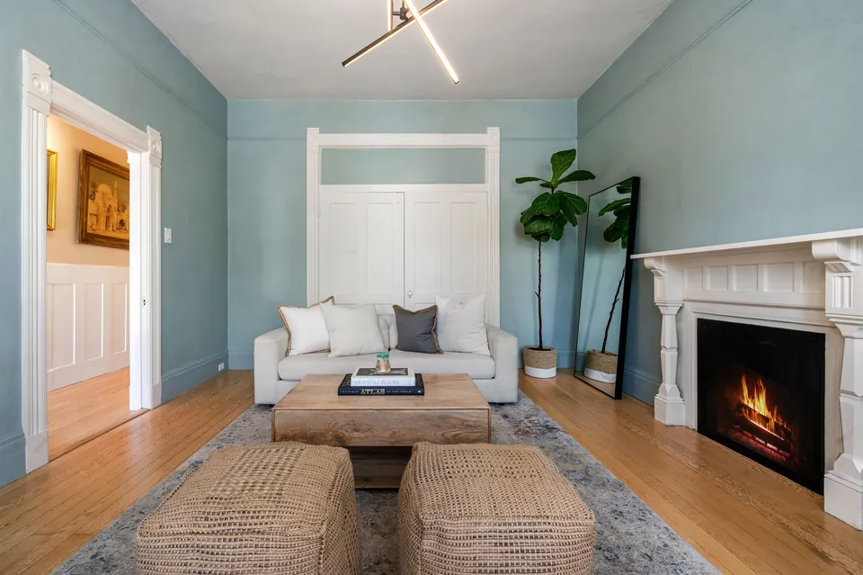 Living room with original fireplace and period trim
