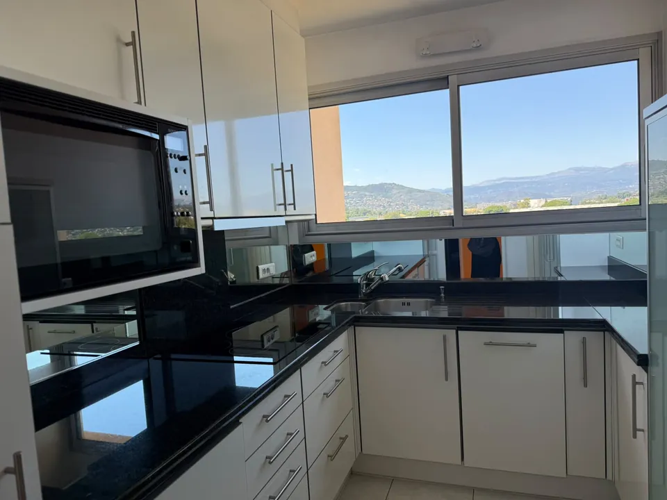 Kitchen with granite counters and hillside view