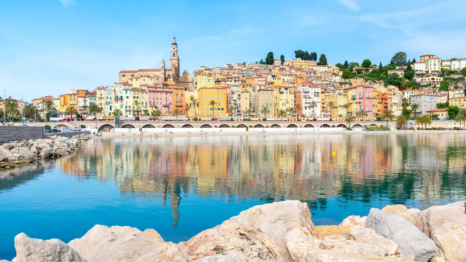 Menton's old town reflected in the calm sea