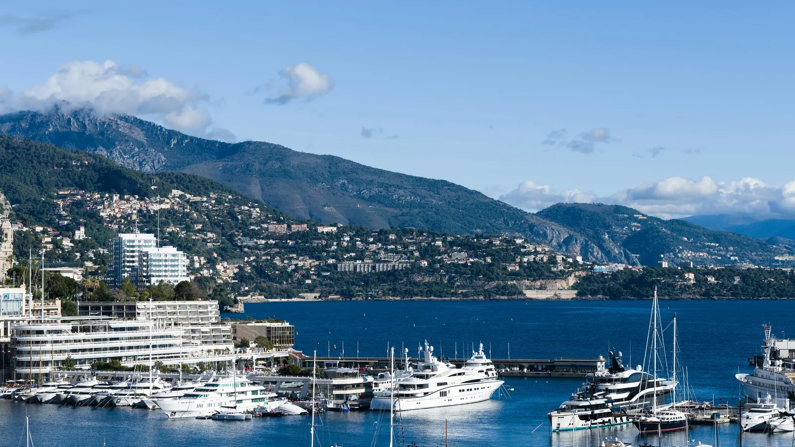 Yachts in Port Hercule, with Monte-Carlo's buildings and the coastal hills beyond