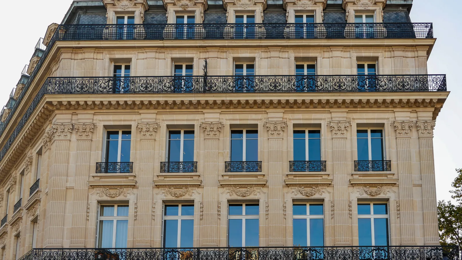 A Haussmann apartment building in Paris with carved stone and wrought-iron balconies on every floor