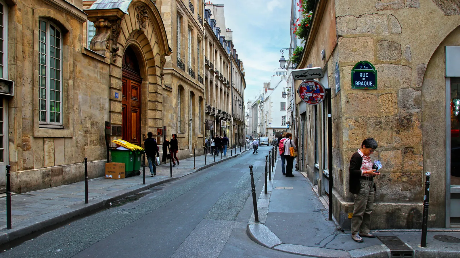 A quiet street in the Marais lined with old stone mansions