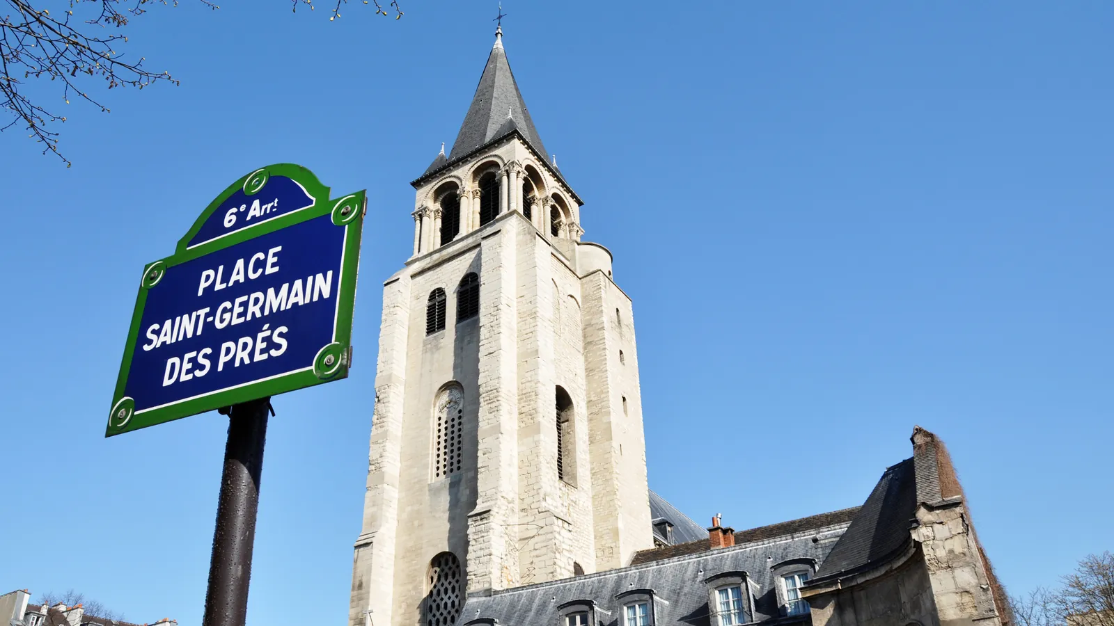 The Place Saint-Germain-des-Prés street sign in front of the abbey church's bell tower in the 6th arrondissement