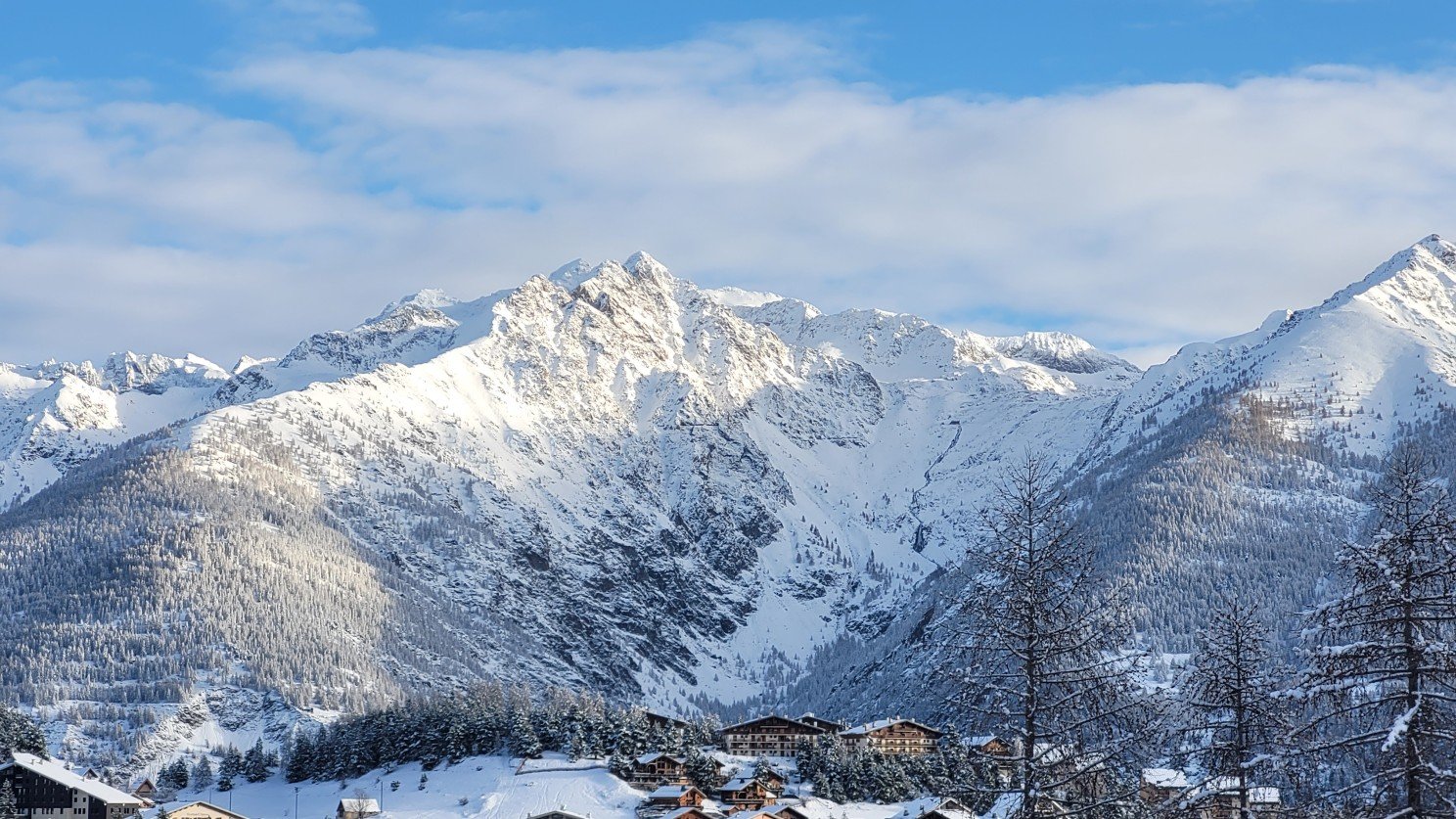 Beach View with Snow-Capped Peaks: "A stunning view of snow-capped mountains from a beach on the French Riviera."