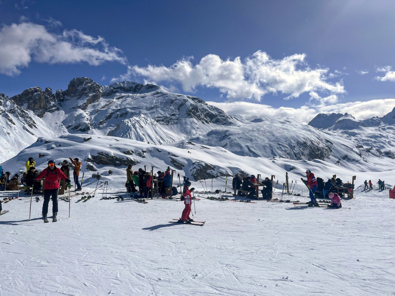 Happy skiers picnicking on mountain
